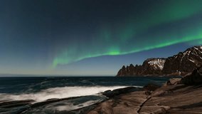 Northern Lights glowing over the Norwegian sea with rugged mountains in a timelapse - Powered by Shutterstock - Get 15% off with code: PIKWIZARD15