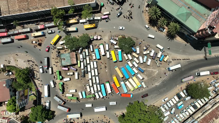 Aerial view of a bustling matatu terminus with colorful buses and busy streets, Nairobi, Nairobi, Kenya.