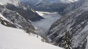 View of snow covered mountains and mist in Aosta Valley from Pavillon on a sunny day, Courmayeur, Aosta Valley, Italian Alps, Italy - Powered by Shutterstock - Get 15% off with code: PIKWIZARD15