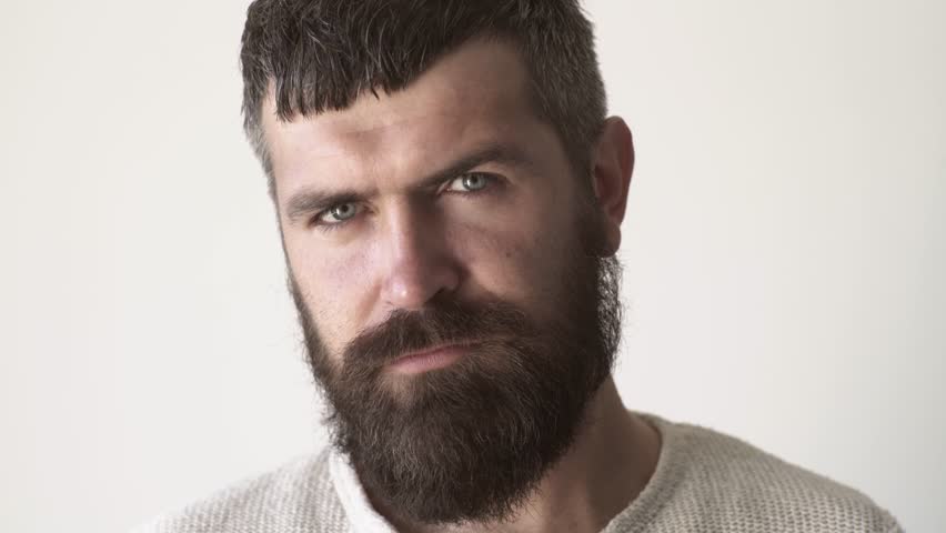 Serious bearded man closeup. Confident male model portrait. Handsome bearded guy. Hipster man with a long beard. Thoughtful bearded male face closeup. serious man. Confident bearded man.