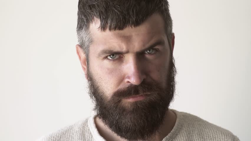 Serious bearded man closeup. Confident male model portrait. Handsome bearded guy. Hipster man with a long beard. Thoughtful bearded male face closeup. serious man. Confident bearded man.