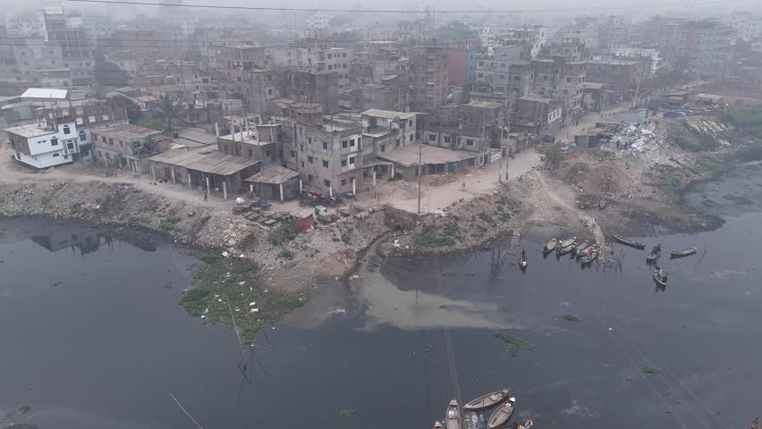 Aerial view of a foggy and congested urban landscape with boats on the river and buildings in the town, Dhaka, Dhaka, Bangladesh.