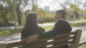 A young couple shares a happy, loving moment on a park bench, enjoying the peaceful autumn atmosphere together. Their smiles and closeness show a strong, joyful bond. - Powered by Shutterstock - Get 15% off with code: PIKWIZARD15