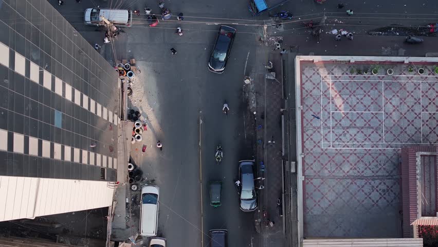 Aerial view of bustling traffic and crowded streets in a dynamic urban landscape, Dhaka, Bangladesh.