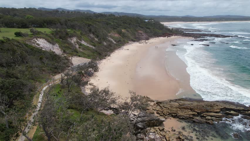 Bartletts Beach And Headland Reserve With Waves Splashing In Bonny Hills, New South Wales, Australia. aerial pullback shot