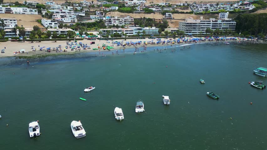 Beautiful and sunny beach in Lima, Peru, bustling with vacationers enjoying the summer.