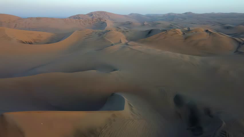 Sand dunes desert Peru South America dry land landscape aerial drone view empty