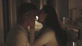 Romantic couple embracing tenderly in candlelit kitchen - Powered by Shutterstock - Get 15% off with code: PIKWIZARD15