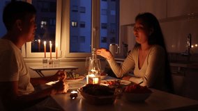 Romantic couple holding hands during candlelit dinner at home - Powered by Shutterstock - Get 15% off with code: PIKWIZARD15