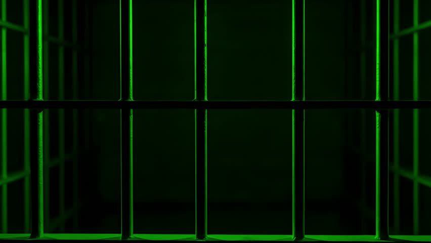 Prison Cell Bars Casting Shadows: Symbolizing Confinement and Loss of Freedom. metal prison cell bars casting shadows on the floor, representing themes of incarceration, confinement