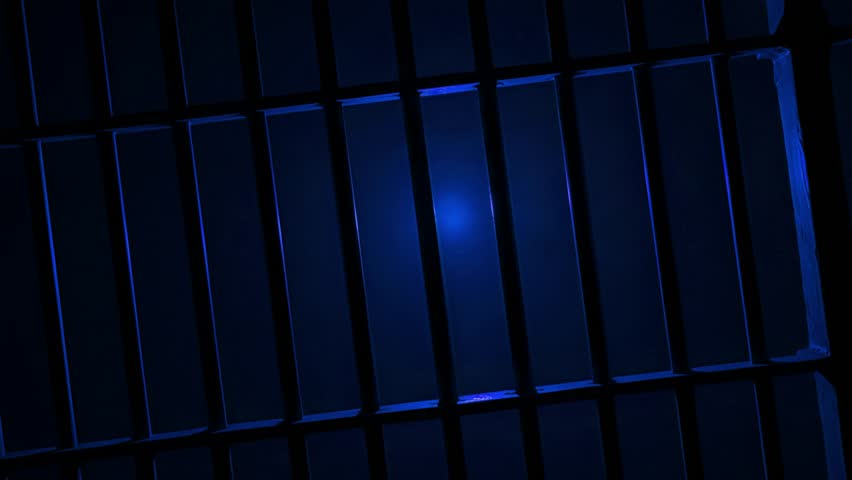 Prison Cell Bars Casting Shadows: Symbolizing Confinement and Loss of Freedom. metal prison cell bars casting shadows on the floor, representing themes of incarceration, confinement