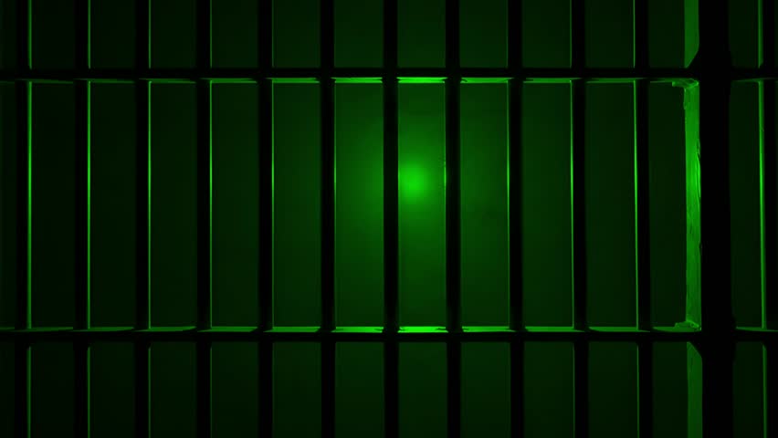 Prison Cell Bars Casting Shadows: Symbolizing Confinement and Loss of Freedom. metal prison cell bars casting shadows on the floor, representing themes of incarceration, confinement