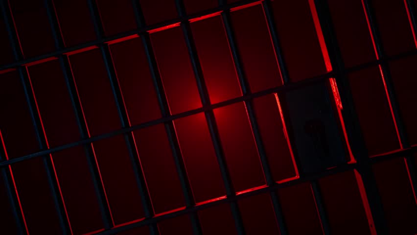Prison Cell Bars Casting Shadows: Symbolizing Confinement and Loss of Freedom. metal prison cell bars casting shadows on the floor, representing themes of incarceration, confinement