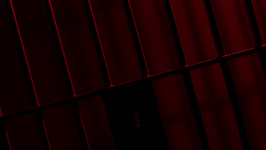 Prison Cell Bars Casting Shadows: Symbolizing Confinement and Loss of Freedom. metal prison cell bars casting shadows on the floor, representing themes of incarceration, confinement