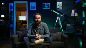 Ecstatic sports fan watching live match broadcast at home, shouting to celebrate favorite team scoring. Euphoric man yelling, doing frantic hand gesturing, delighted about goal, camera B - Powered by Shutterstock - Get 15% off with code: PIKWIZARD15