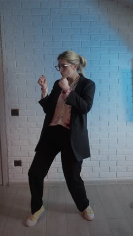 A Stylish Young Woman Joyfully Dancing in a Contemporary, Modern Setting Filled with Life