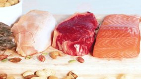 A vibrant display of various protein foods including meats, seafood, and nuts against a blue background - Powered by Shutterstock - Get 15% off with code: PIKWIZARD15