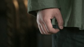 A man in coarse clothes clenches his right hand into a fist. Close-up of his hand - Powered by Shutterstock - Get 15% off with code: PIKWIZARD15