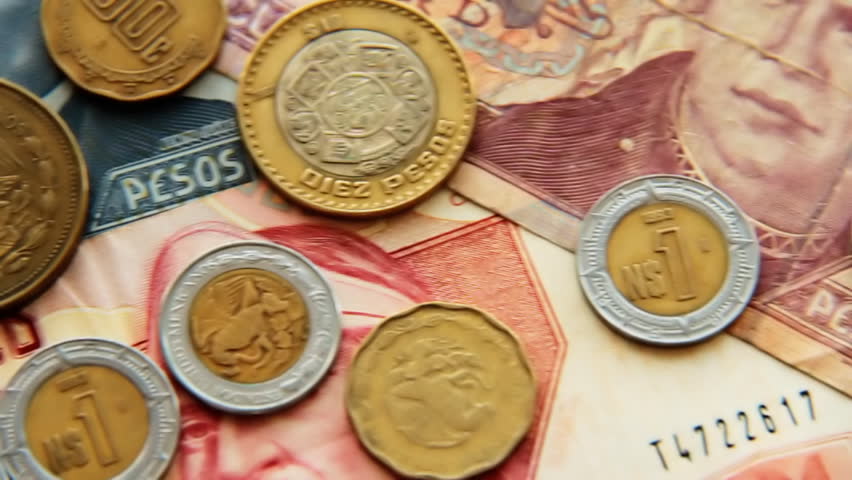 Mexican Pesos 4. Mexican paper money and metal coin currency. Panning.
