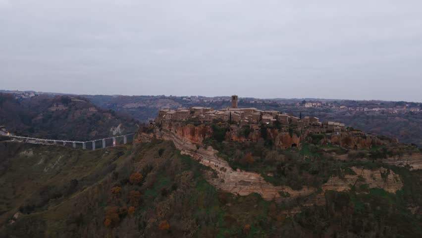 Civita di Bagnoregio with long and hig footbridge, Viterbo in Italy. Aerial lateral view, copy space
