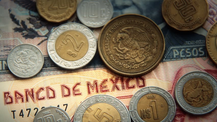 Mexican Pesos 3. Mexican paper money and metal coin currency. Blurred and goes
