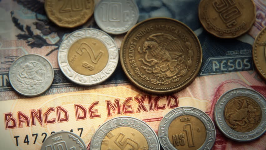 Mexican Pesos 2. Mexican paper money and metal coin currency. Blurred and goes