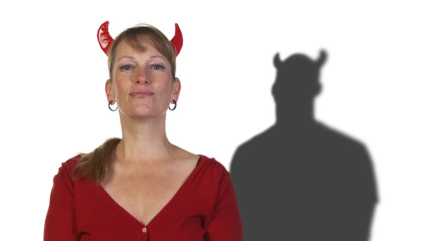 Demonic man shadow lurks behind a woman with devil horns.