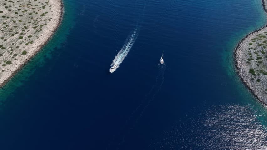 Tilt up shot of a large vessel sailing near the islands of the Kornati archipelago in Croatia.