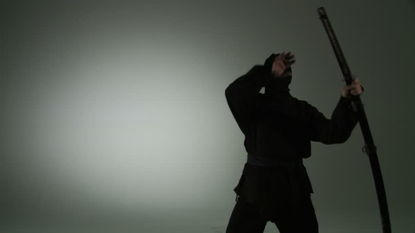 Profile view of a masked ninja unsheathing a massive two-handed katana (Japanese
