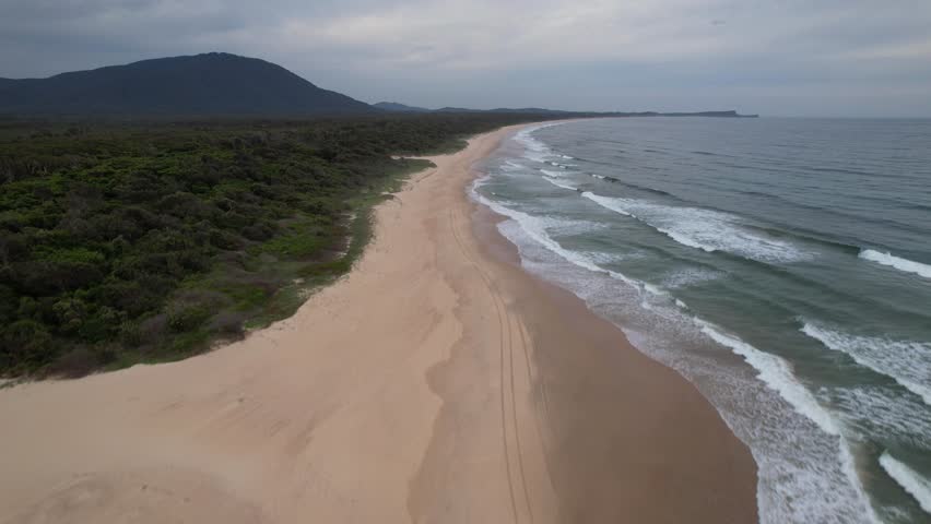 Sandy Diamond Head Beach With Vegetation And Waves Splashing. New South Wales, Australia. drone shot