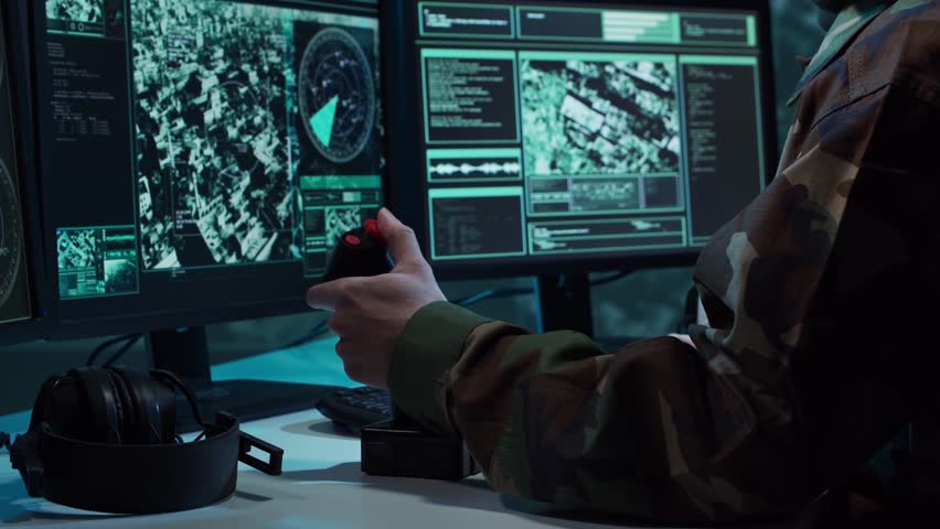 Military soldier operating advanced technology in a command center.