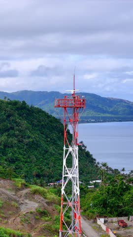 An aerial perspective showcasing a vital radio relay tower above Surigao City, ensuring uninterrupted maritime signals for cargo ships and local vessels alike.