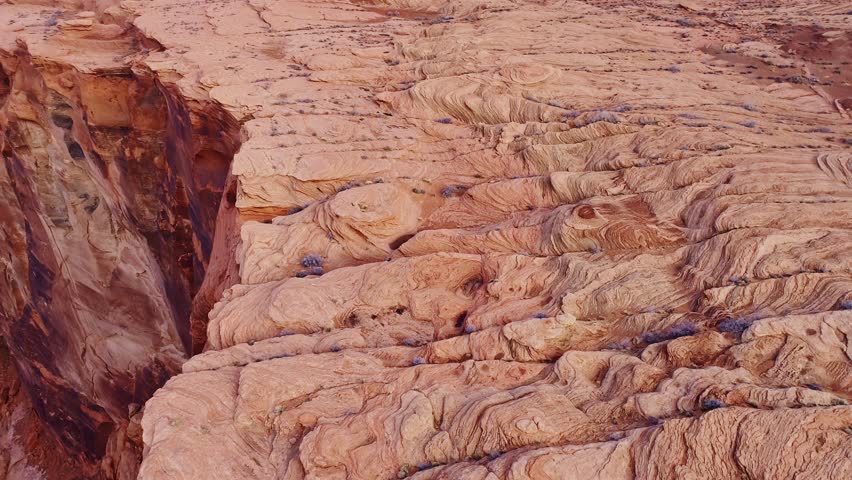 Intricate rock layers of Horseshoe Bend glow in warm sunrise hues in Arizona USA