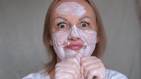 man fooling around using white cream face mask. sleek eyes funny and sloppy apply too much cream on your face. extravagance - Powered by Shutterstock - Get 15% off with code: PIKWIZARD15