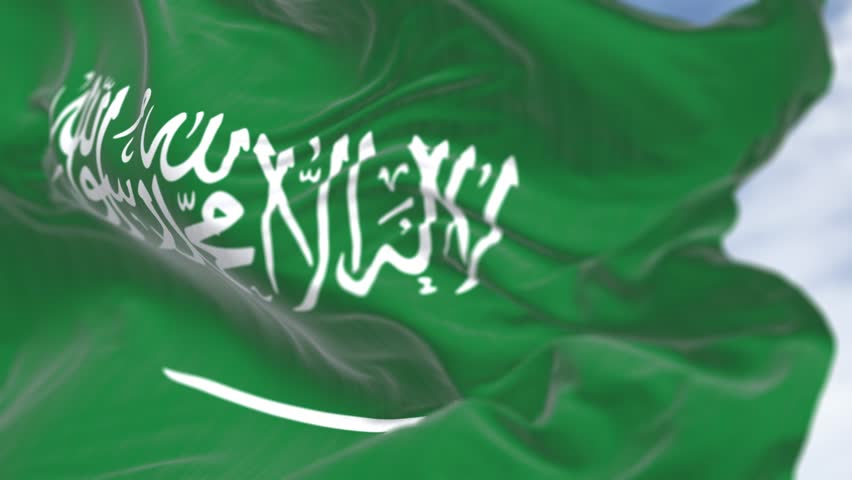 Close- up of the Saudi Arabian national flag waving in the wind. Green field with Shahada and sword in Thuluth script. Seamless 3d render animation. Slow motion loop. Selective focus. Cinema 4k
