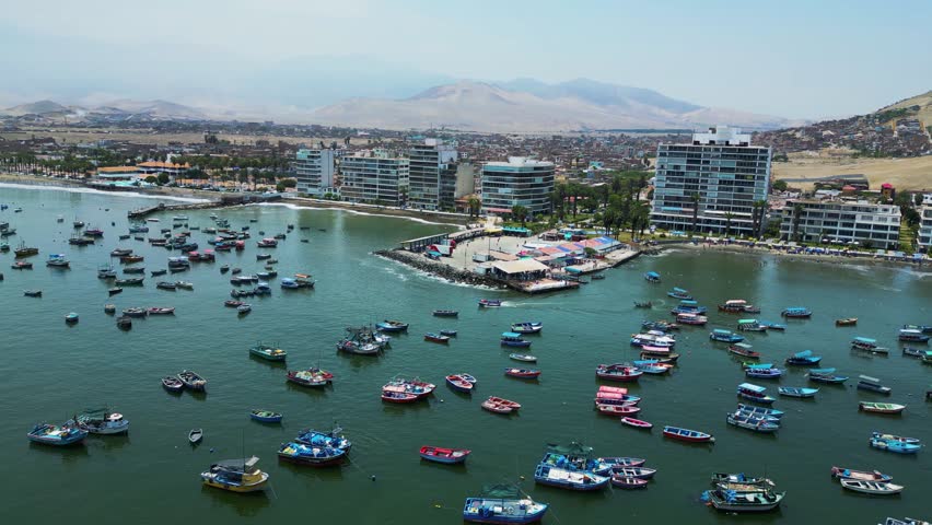 Port city of Ancon, Peru, with recreational and fishing activity seen from a drone on a sunny day.