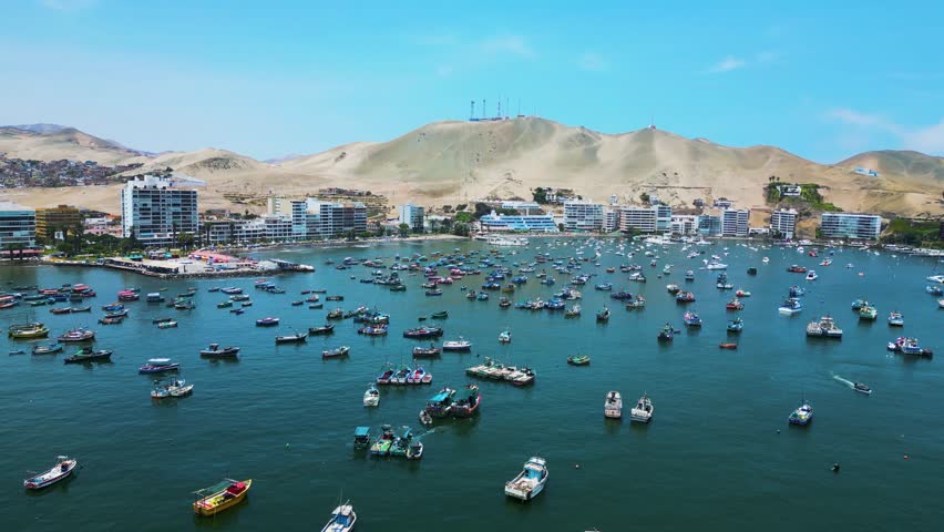 Aerial view of Ancon Beach, Lima, Peru, with boats scattered across the sea on a bright summer day.