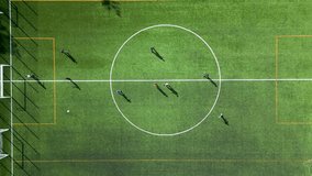 Top-down view of a football training session on a green field with players and equipment visible - Powered by Shutterstock - Get 15% off with code: PIKWIZARD15