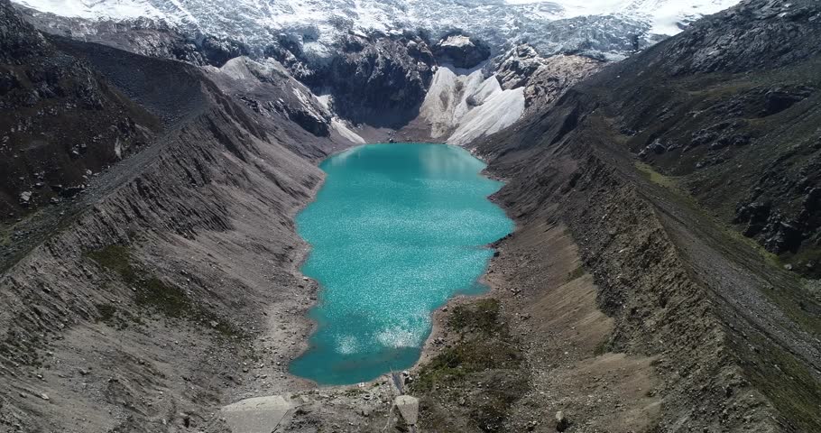 “A breathtaking turquoise glacial lake surrounded by rugged Andean peaks and pristine snow. Ideal for travel blogs, nature videos, and adventure videography