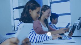 In school, students using laptops with animation of music and technology icons. education, learning, digital, innovation, creativity, multimedia - Powered by Shutterstock - Get 15% off with code: PIKWIZARD15