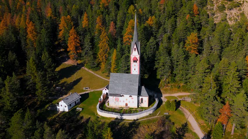 Church of St. Jacob with mountains in the background. Italy