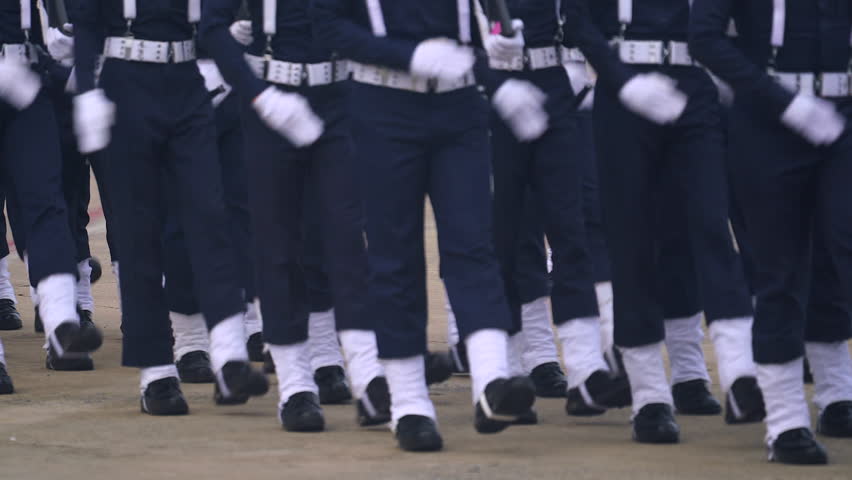 A line of soldiers is marching in a parade. platoon military army marche street slowmotion