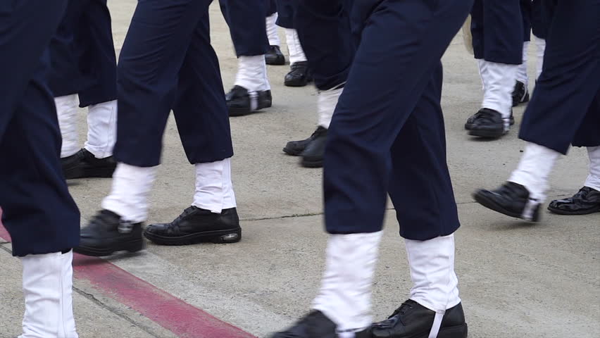 A line of soldiers is marching in a parade. platoon military army marche street slowmotion