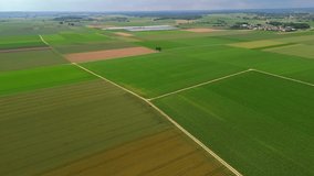 Aerial view of Bavarian farmland in Germany during summer. Green fields, dirt roads, and small chapel at crossroads. Solar panels in the background highlight sustainable farming and renewable energy.  - Powered by Shutterstock - Get 15% off with code: PIKWIZARD15