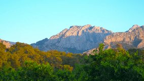 Majestic mountain range bathed in golden light at sunrise. Golden sunlight casting long shadows across mountain slopes during breathtaking sunrise - Powered by Shutterstock - Get 15% off with code: PIKWIZARD15