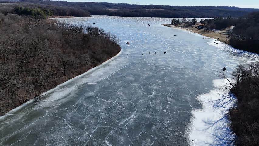 drone footage of ice fisherman on frozen Blackhawk lake in wisconsin