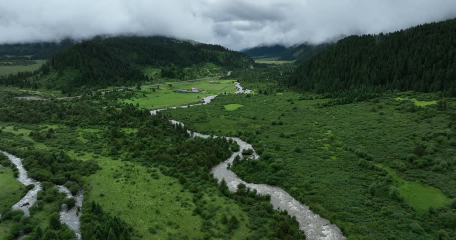 Aerial footage of beautiful high altitude grassland and mountain landscape