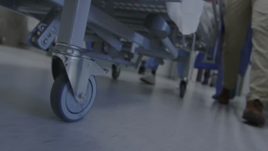 Stock market data animation over hospital staff moving medical equipment. Finance, healthcare, intersection, collaboration, innovation, synergy - Powered by Shutterstock - Get 15% off with code: PIKWIZARD15