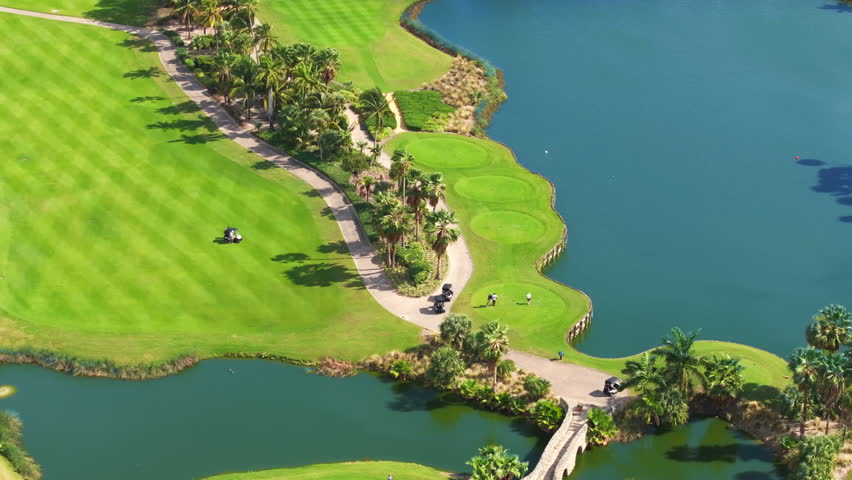 This aerial shot showcases Floridas picturesque golf courses, vibrant greenery, sparkling blue water, and rich nature, creating an idyllic landscape for relaxation and leisure