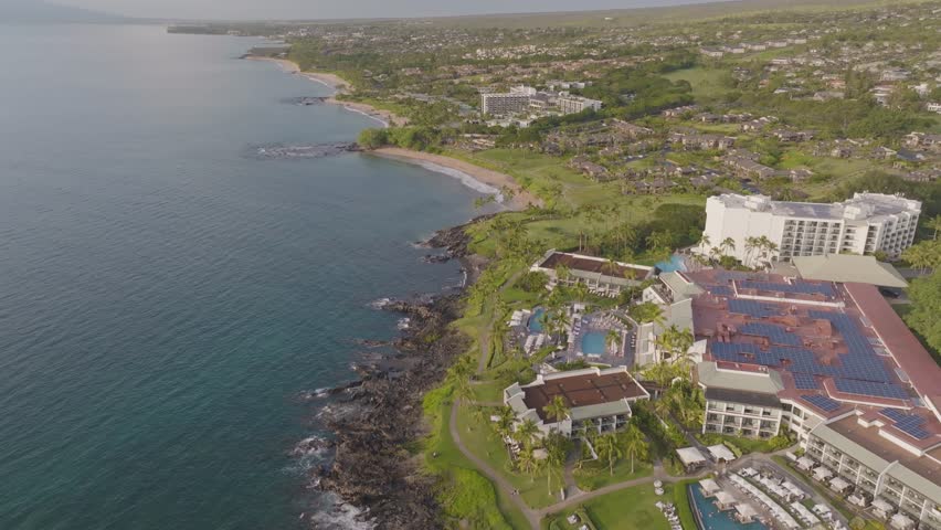 Aerial view of Wailea Maui, Hawaii beachfront resorts and beaches landscape along Wailea beach path during golden hour sunset - 4K Drone
